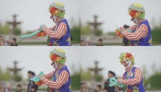 小丑在给孩子吹气球高清在线视频素材下载