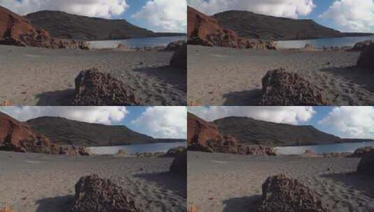 岩石海岸连接着黑色沙滩高清在线视频素材下载