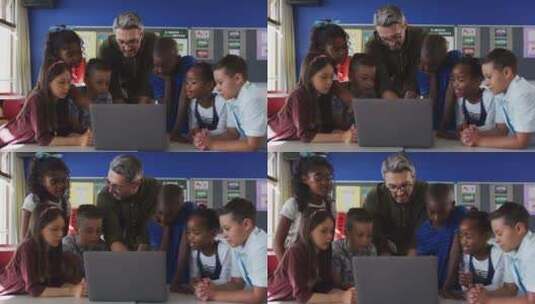 多样化的男老师和一群看着笔记本电脑的学童高清在线视频素材下载