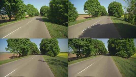 行驶在树木覆盖的空旷道路上高清在线视频素材下载
