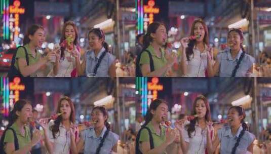 女孩和朋友快乐户外旅行，吃糖葫芦高清在线视频素材下载