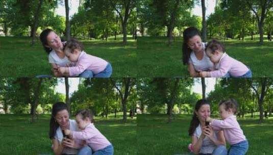 一个婴儿试图从母亲手中拿走手机，但她拒绝高清在线视频素材下载