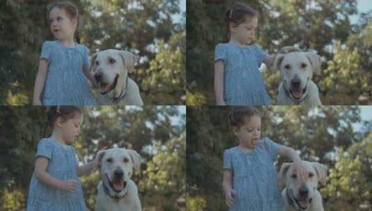 小女孩抱着她的狗，在花园里掐死了他的脖子高清在线视频素材下载