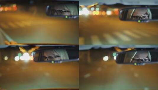 戴眼镜的女人开车穿过夜城高清在线视频素材下载