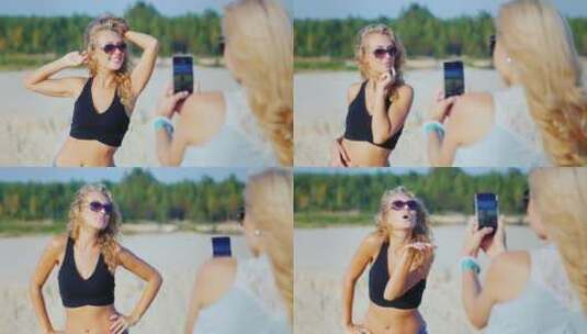 女人用手机在海滩上拍照高清在线视频素材下载