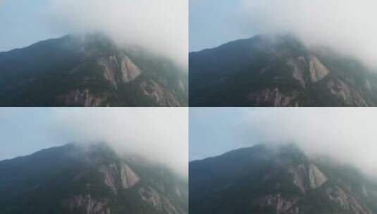 云雾中若隐若现的崖壁山高清在线视频素材下载