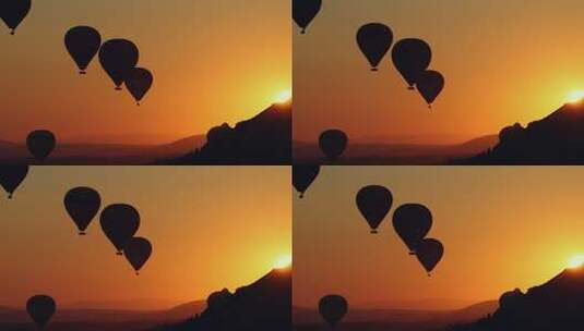 热气球在充满活力的橙色日落天空中飞行高清在线视频素材下载