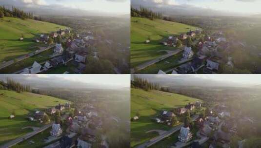 坐落在山丘之间的山村的日落无人机景观高清在线视频素材下载