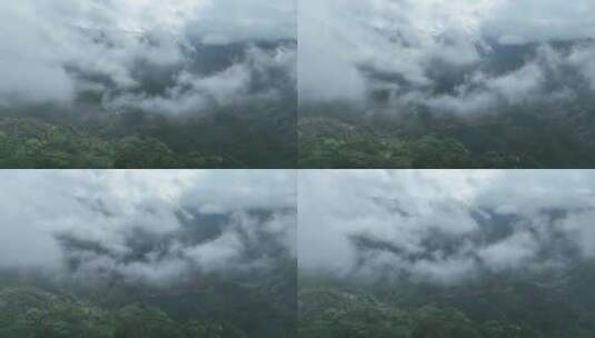 航拍云雾缭绕的大山高空固定镜头广西圣堂山高清在线视频素材下载