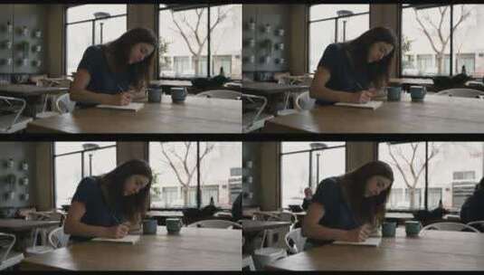 女人在咖啡馆的桌子上书写高清在线视频素材下载