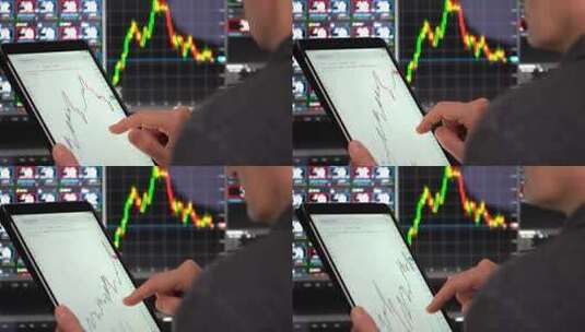 商人在平板上分析股票图表高清在线视频素材下载