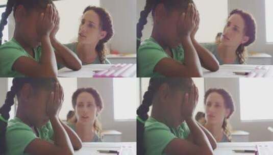 白人女教师在课堂上支持悲伤的非裔女孩的视频高清在线视频素材下载