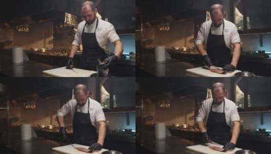 厨师在餐厅的白色砧板上切鱼高清在线视频素材下载
