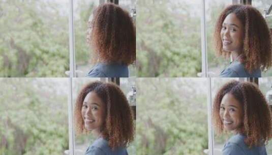 年轻的非裔美国妇女在家窗边微笑，有复印空高清在线视频素材下载