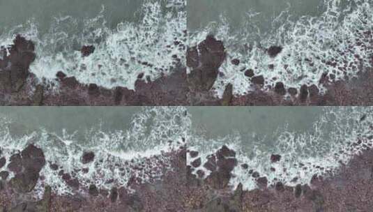 海岸礁石沙滩海水拍打礁石阴天海滩海浪冲刷高清在线视频素材下载