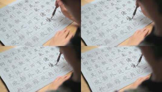 用字帖练习毛笔字的亚裔女性高清在线视频素材下载