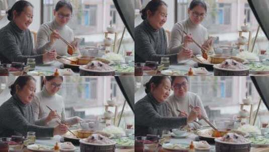 母亲和女儿开心吃火锅高清在线视频素材下载