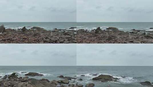 阴天大海礁石海岸边航拍海边岩石大海上礁石高清在线视频素材下载