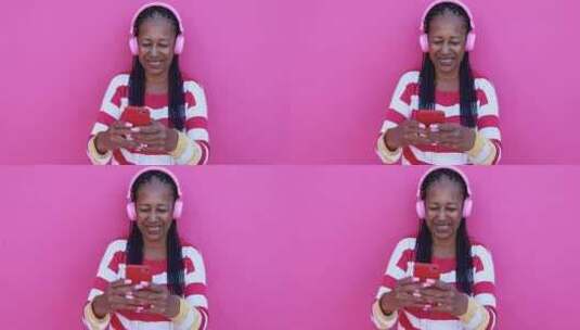 来自智能手机应用程序的资深非洲女性收听音乐播放列表高清在线视频素材下载