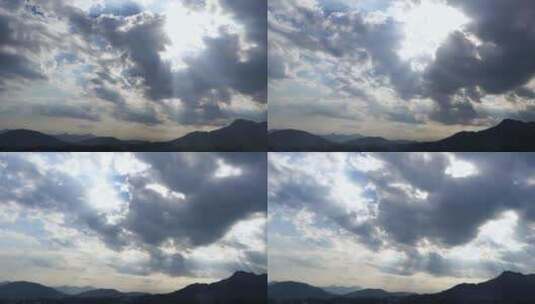 山峰延时天空阳光穿过云朵上帝之光丁达尔光高清在线视频素材下载