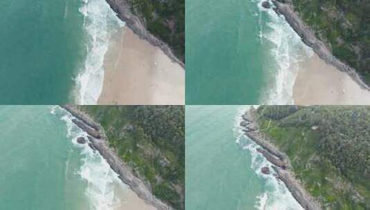 航拍海浪拍打着沙滩和礁石高清在线视频素材下载