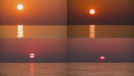 海上大红日日落的延时。橙色阳光路径与海面反射高清在线视频素材下载