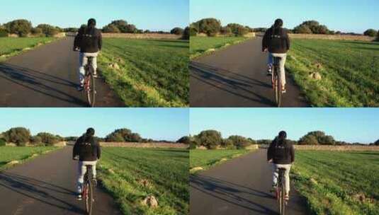 在柏油路上骑自行车的男人高清在线视频素材下载
