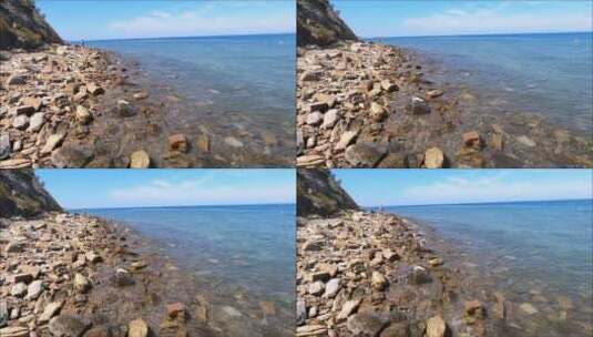 清澈的海水拍打着石滩高清在线视频素材下载