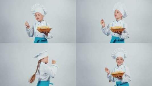 小女孩穿厨师服装端着美食高清在线视频素材下载