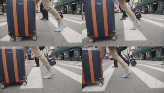 行人推着行李箱走在街道上高清在线视频素材下载