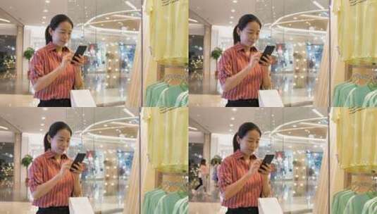 亚洲东方中国女性在商场内挑选衣服购物高清在线视频素材下载