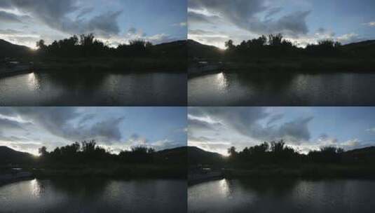 乡村傍晚夕阳森林湖面波光粼粼高清在线视频素材下载