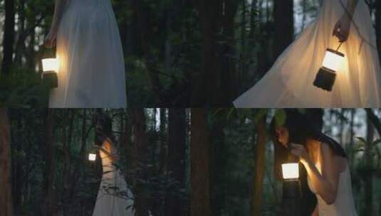 穿白色长裙的女孩提着马灯在黑暗的树林行走高清在线视频素材下载