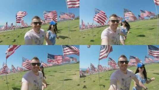 男女在美国国旗间奔跑高清在线视频素材下载