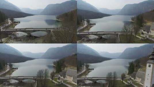 斯洛文尼亚博辛吉湖上桥梁和教堂的无人机景观高清在线视频素材下载