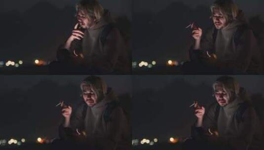 男人在夜晚抽着烟看手机高清在线视频素材下载