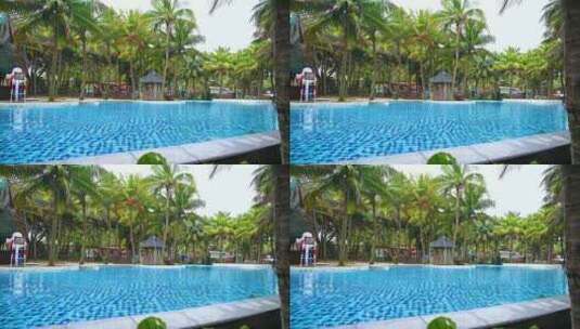 海南三亚椰林与蓝色透明游泳池高清在线视频素材下载