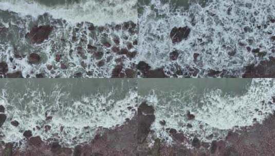 海岸礁石沙滩海水拍打礁石阴天海滩海浪冲刷高清在线视频素材下载