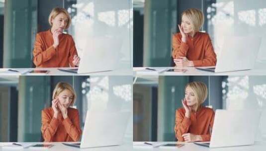 悲伤的年轻金发女子坐在办公室的办公桌前，高清在线视频素材下载
