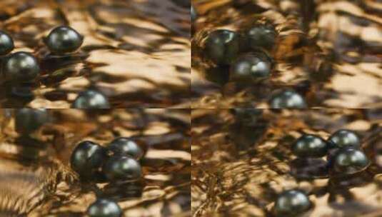 大溪地黑珍珠在金色盘子里的水中滚动高清在线视频素材下载