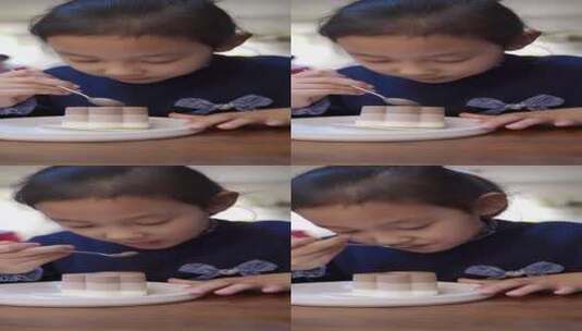 在餐厅吃冰激凌蛋糕的中国女孩高清在线视频素材下载