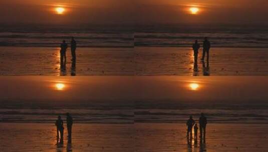 黄昏在海滩玩耍的一家三口剪影高清在线视频素材下载