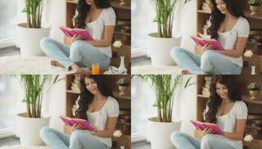 女孩坐在地板上看书高清在线视频素材下载
