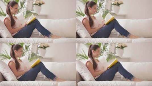 女孩坐在沙发上看书高清在线视频素材下载