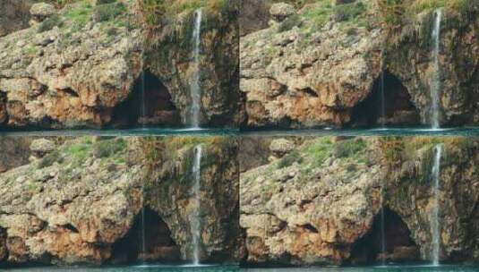 海边岩石海岸线上的瀑布高清在线视频素材下载