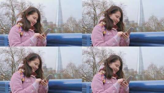 女孩在伦敦塔桥上使用手机高清在线视频素材下载