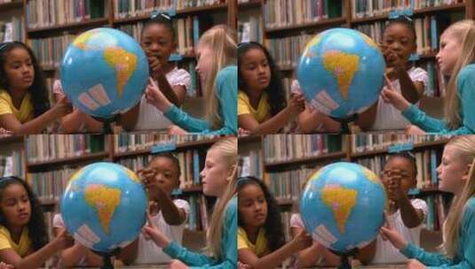 小女孩在图书馆看地球仪高清在线视频素材下载