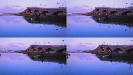 威海滨海沙滩石桥与黄昏海边钓鱼人高清在线视频素材下载