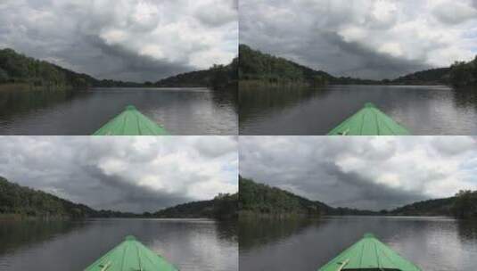 独木舟在穿过河流天际线景观高清在线视频素材下载