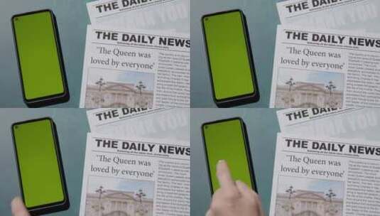 用手点击报纸旁边的绿屏手机高清在线视频素材下载